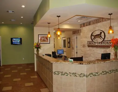 A reception area with a desk and television.