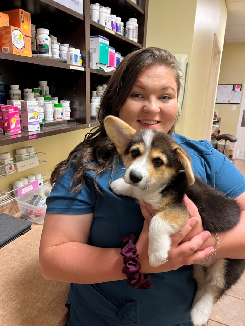 A woman holding a puppy in her arms.