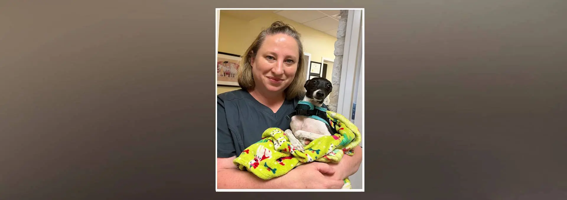 A woman holding a dog in her arms.